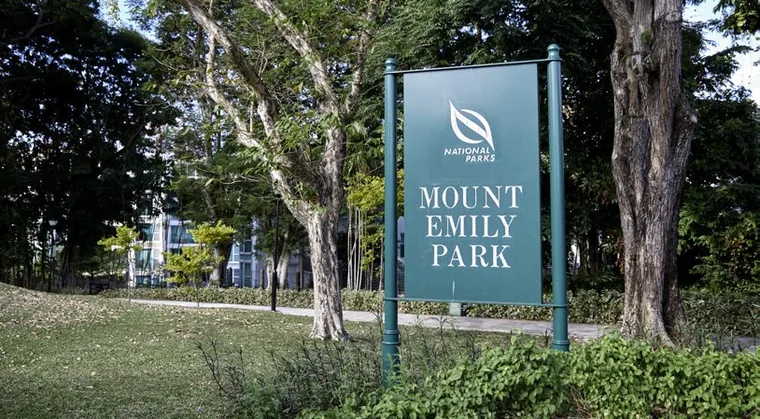Mount Emily Park signboard among mature trees, beside Duet @ Emily